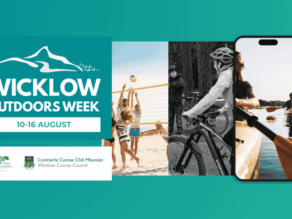 Digital banner for Wicklow Outdoors Week, running 10–16 August. The left side features a prominent teal block containing the mountain outline logo and event dates, with the Wicklow Sports & Recreation Partnership and Wicklow County Council logos directly underneath. The rest of the banner displays a horizontal carousel showcasing outdoor activities: hiking, beach volleyball, mountain biking, kayaking (displayed inside a smartphone frame mock-up), and a scenic view of the Wicklow coastline.